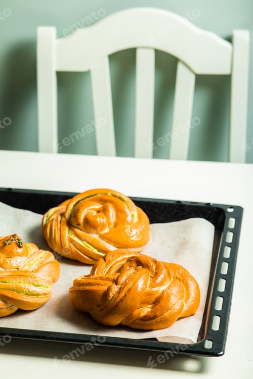 Preview: homemade buns with cream and pistachio cream decorated with thyme freshly baked for breakfast