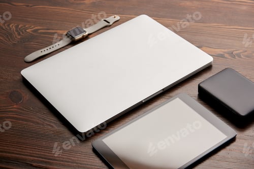 Preview: close-up shot of laptop with digital tablet, smart watch and portable hdd on wooden table