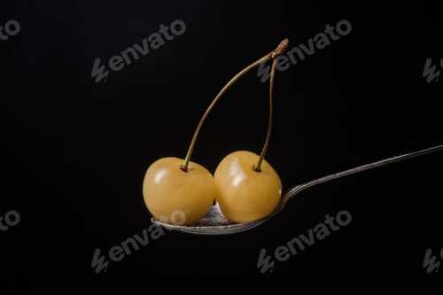 Preview: Sweet cherry isolated over black background.