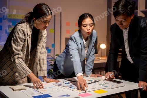 Preview: Three people are sitting at a table with a whiteboard in front of them