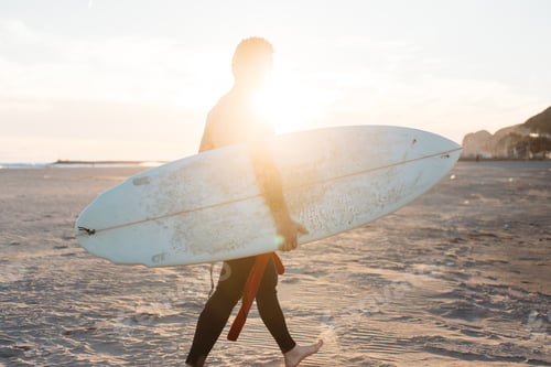 Preview: Hipster trendy surfer on beach with surfboard