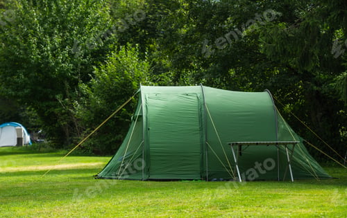 Preview: Camping Setup With Green Tent in Lush Outdoor Area on Sunny Day
