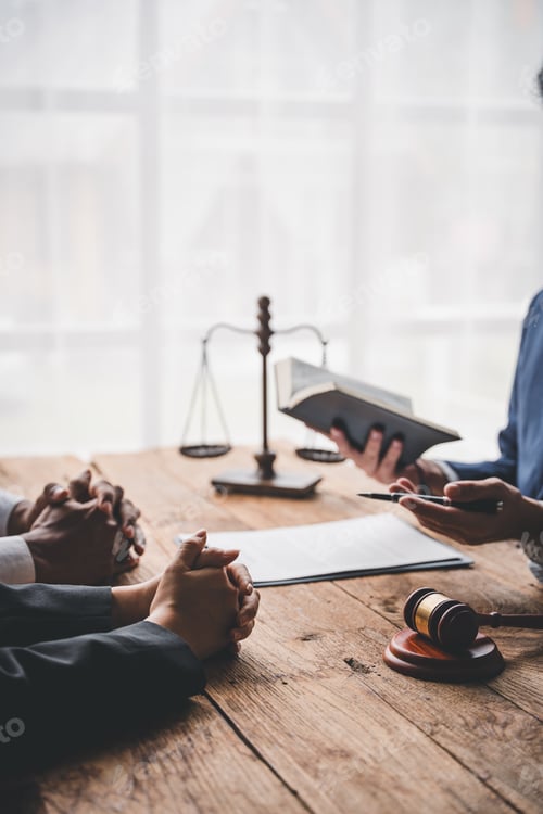 Preview: concept of justice and law A male judge in the courtroom on a wooden table and a male counselor or l
