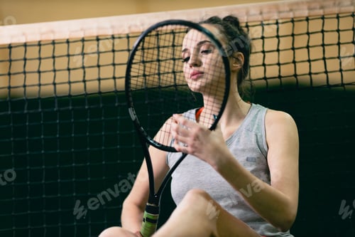 Preview: Tennis woman player portrait with racket and ball at court.