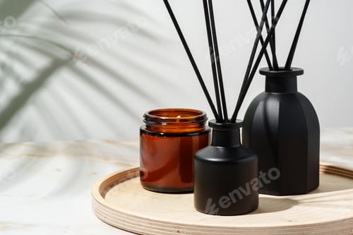Preview: Black Reed Diffuser, Amber Candle, and Wooden Tray on White Surface