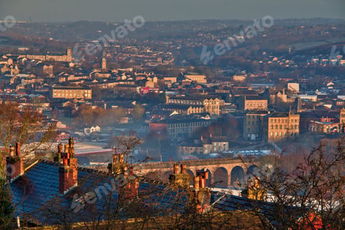 Preview: Aerial shot of a small town in England with old buildings and autumn trees