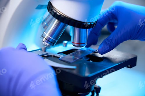 Preview: Specialist works with biomaterial samples under a powerful microscope