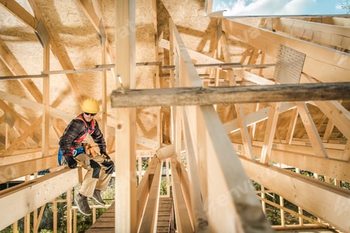 Preview: Construction Worker Sitting on a Wooden Roof Beam