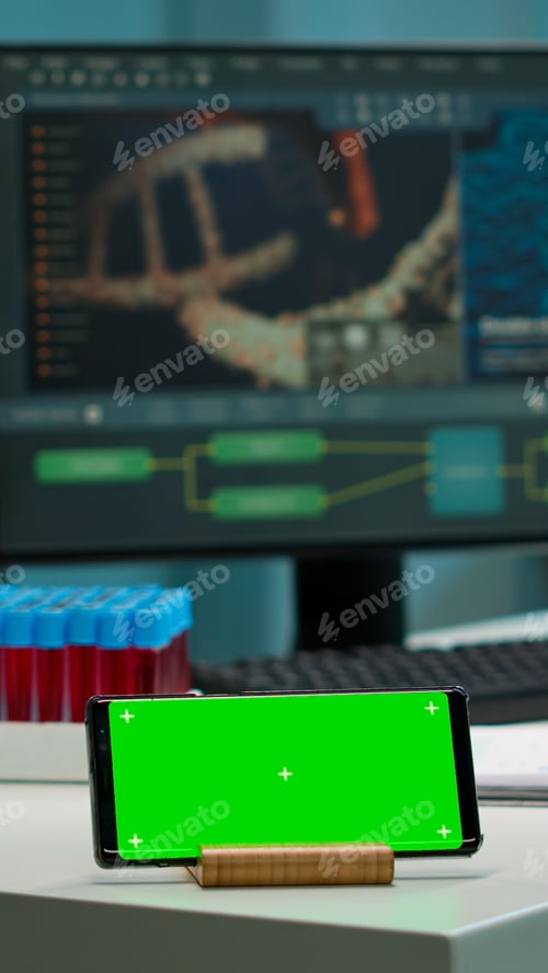 Preview: Horizontal mobile phone with green screen working in labooratory
