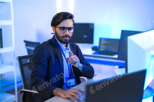 Preview: Stressed IT professional reacts with shock to a critical system error on his computer.