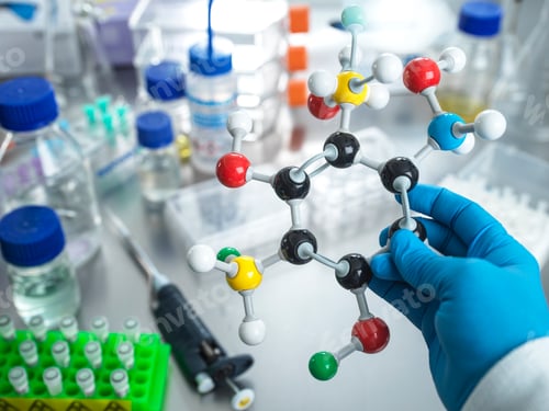 Preview: Scientist holding molecular model in laboratory