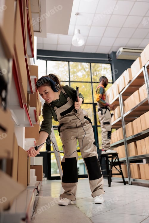 Preview: Warehouse manager scanning cardboard box barcode