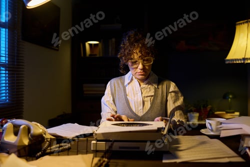 Preview: Portrait of Young Adult Caucasian Woman Typing on Typewriter at Desk