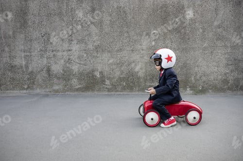 Preview: Funny businessman driving retro kids car outdoor