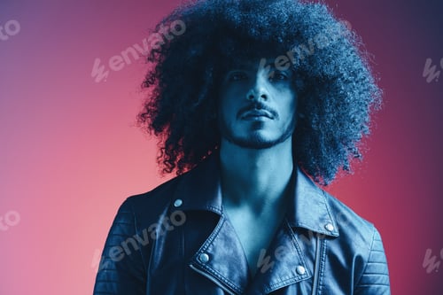 Preview: Portrait of fashion man with curly hair on red background multinational, colored light, black