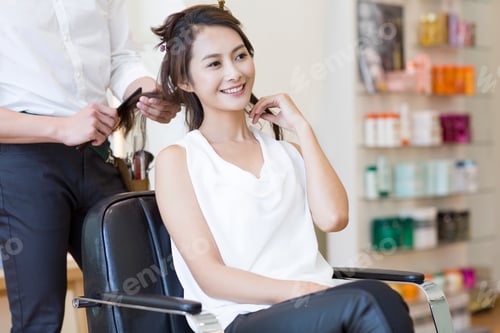 Preview: Woman Smiling While Getting Hair Styled at Salon