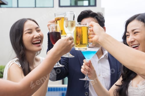 Preview: Young asian friends toasting drinks at a party