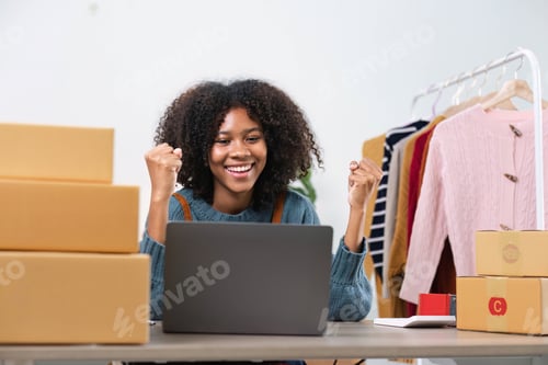 Preview: Happy young Asian woman entrepreneur, Smile for sales success after checking order from online