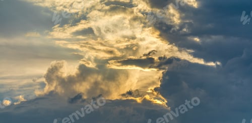 Preview: Cloudy sky with son shining through clouds