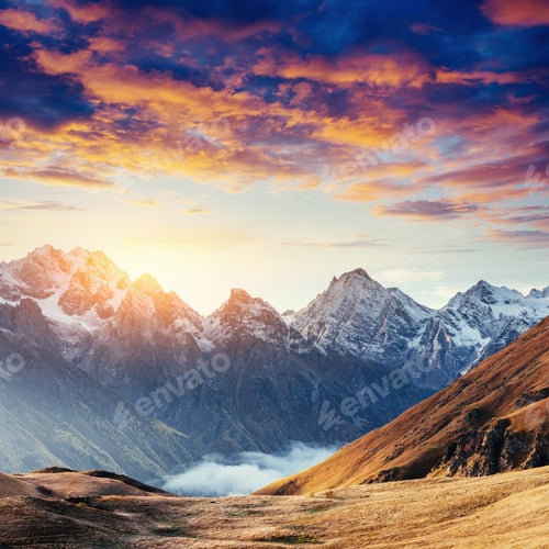 Preview: Autumn landscape and snowy mountain peaks. Fantastic sunset. Vie