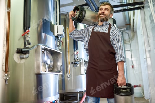 Preview: Happy excited factory worker carrying beer containers