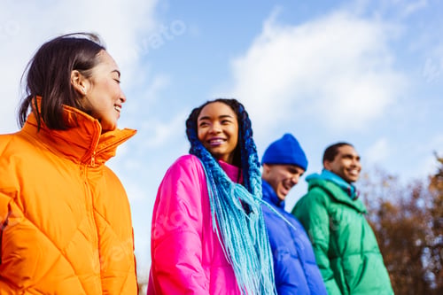 Preview: Multiracial group of young friends meeting outdoors in winter