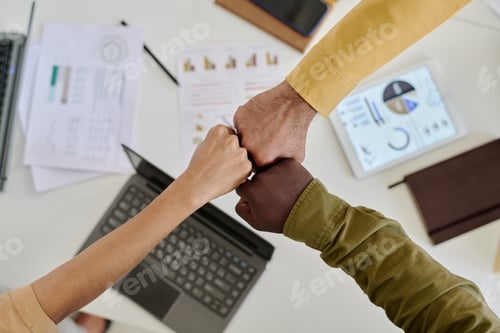 Preview: Celebrating Success with Fist Bump in Office Environment