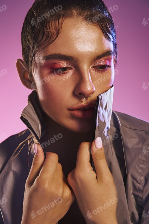 Preview: Stylish woman showcasing modern fashion against a vibrant holographic backdrop in an artistic pose