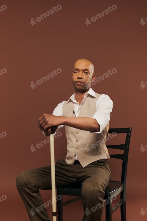 Preview: inclusion, african american man with myasthenia gravis syndrome, sitting on chair and leaning on