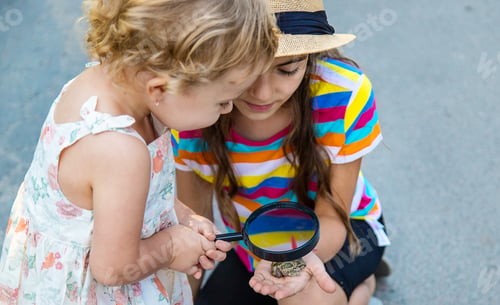 Preview: The child is playing with the frog. Selective focus.