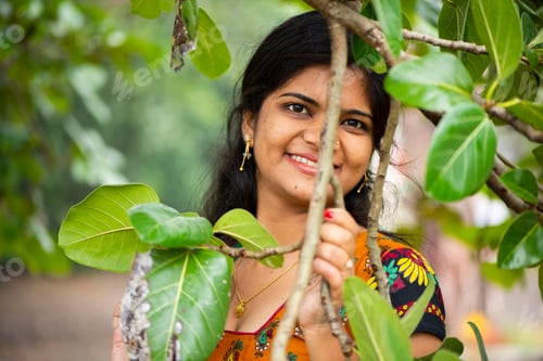Preview: Beautiful girl between nature full of branches of tree.
