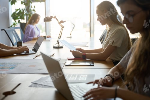 Preview: Group of working people sitting at a desk in room