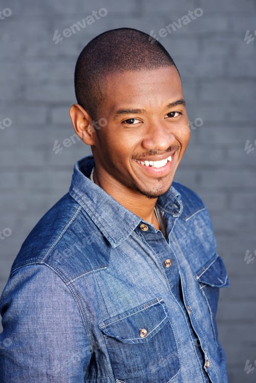 Preview: handsome young african man smiling with blue shirt