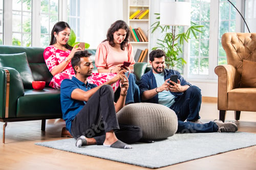 Preview: Indian asian young couple taking selfie using smartphone at home