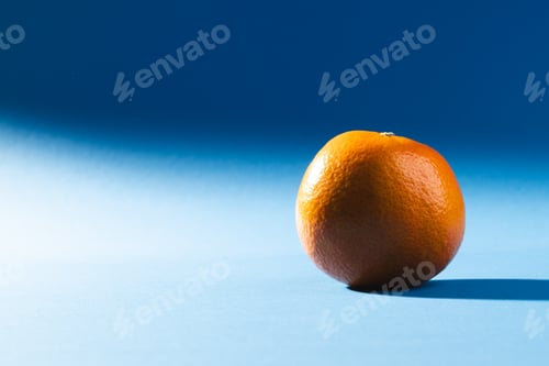 Preview: Close up of orange and copy space on blue background