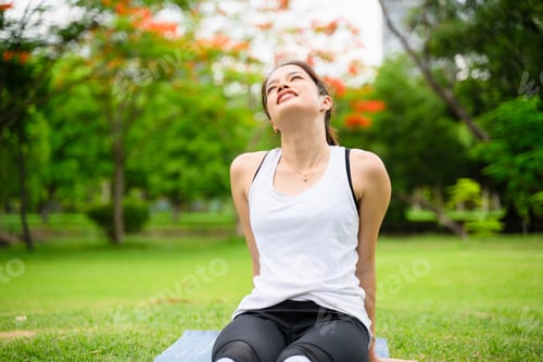 Preview: Healthy young woman enjoying and relaxing yoga outdoor in green park
