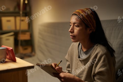 Preview: Woman Writing Notes While Sitting in Cozy Apartment