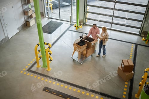Preview: Middle Aged Caucasian Couple Unpacking Boxes Together in Storage Facility