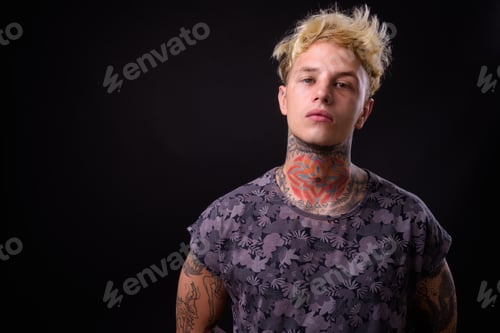 Preview: Young handsome rebellious man with blond hair and tattoos