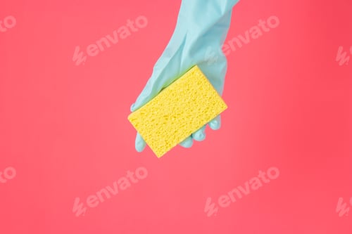 Preview: Yellow Sponge Held in Blue Gloved Hand on Red