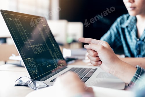 Preview: Teenagers develop programming with blueprint code in laptop monitor.