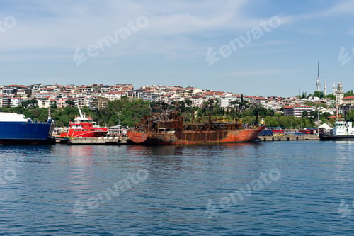 Preview: abandoned rusty ship near coastline in Istanbul city with unban cityscape background