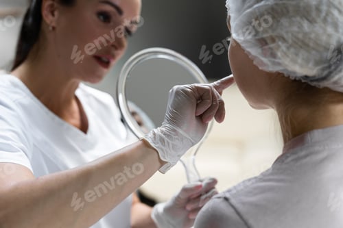 Preview: Permanent makeup artist and her client during lip blushing procedure