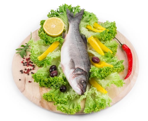 Preview: Fresh seabass fish on lettuce.