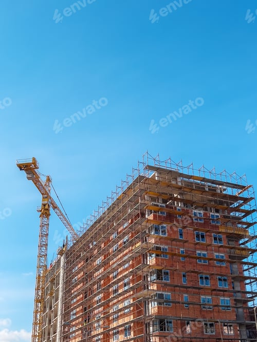 Preview: Apartment building construction site with scaffolding and crane