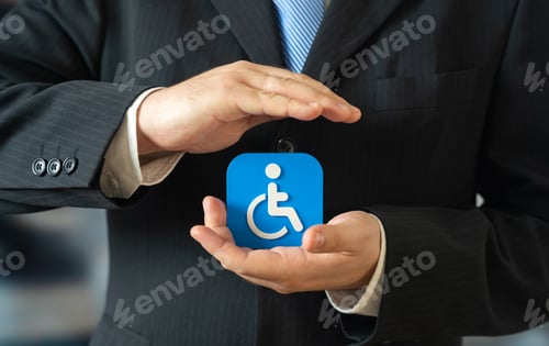 Preview: A businessman holds a symbol for people with disabilities. Support for people with limited mobility