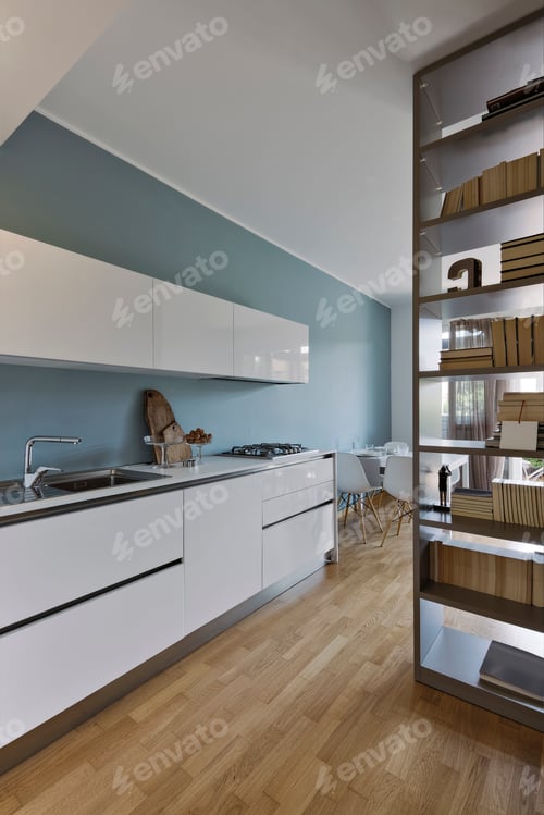 Preview: internal view of a modern white lacquered kitchen with wooden floor