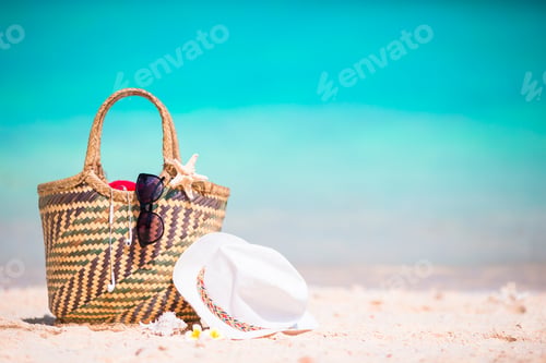 Preview: Beach accessories - straw bag, sunglasses, hat on the beach