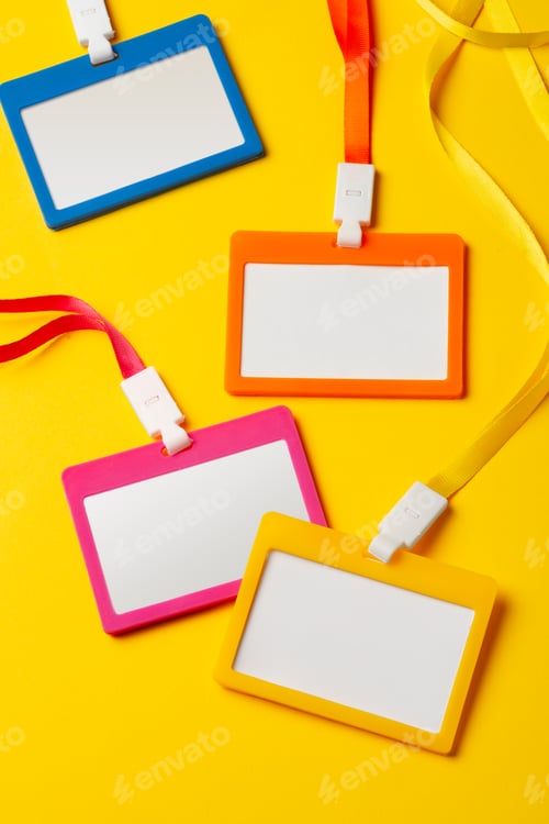 Preview: Colored blank nametags on strings on yellow background