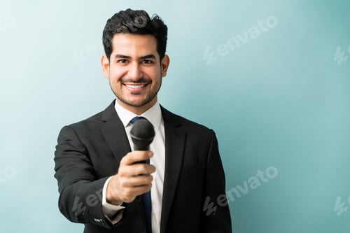 Preview: Hispanic Businessman With Microphone Against Blue Background
